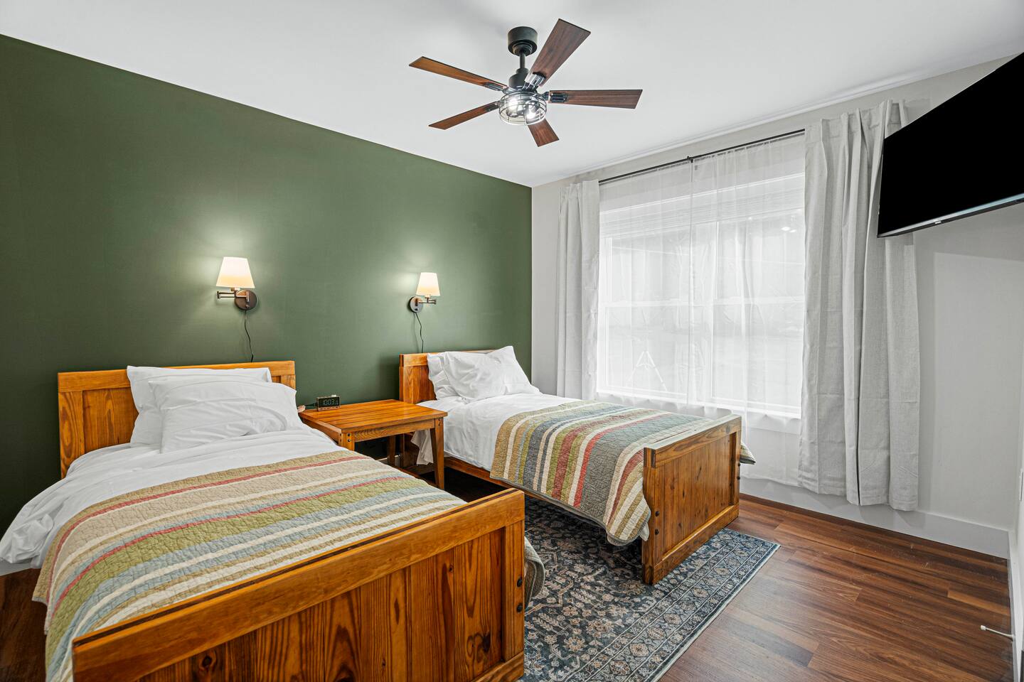 West Mountain Room has indestructible This End Up twin beds, blackout curtains, individual lights, an overhead fan, a Roku TV, and blackout curtains.