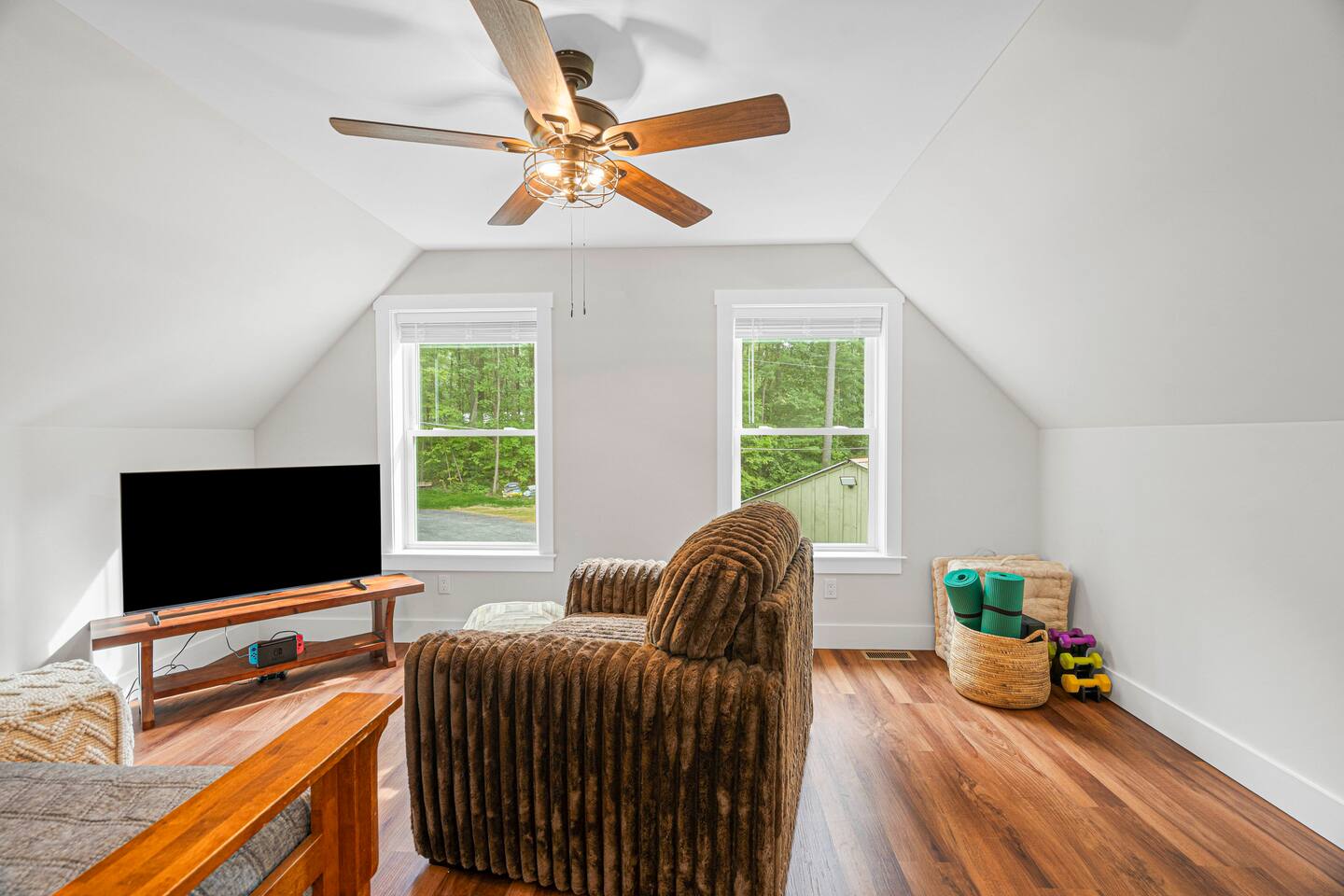 This is the upstairs loft area.  One side features yoga equipment and hand weights, while the other has a Nintendo Switch loaded with games and a daybed with trundle underneath, so sleep 2