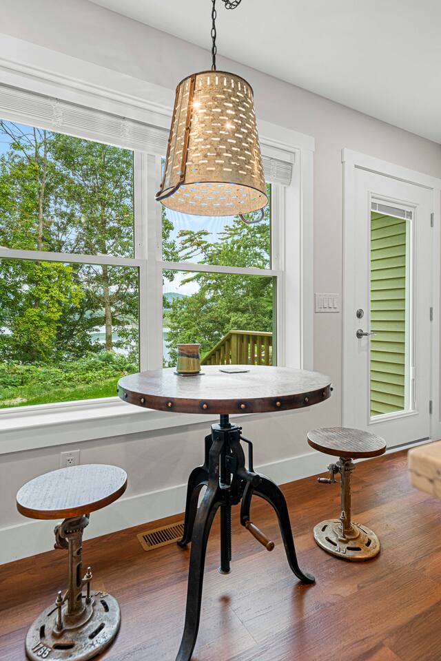 Industrial copper bistro table in the kitchen overlooks the water and mountain - a perfect place for a morning coffee in a handmade mug from the kitchen coffee bar.   The stools and table have adjustable heights to fit everyone's needs.