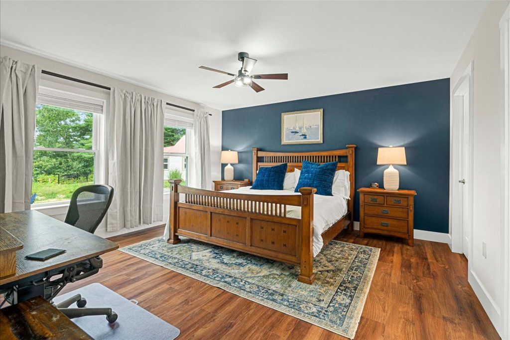 A different view of the Lake George Suite shows the workstation with Aeron chair and electric standing desk to the left