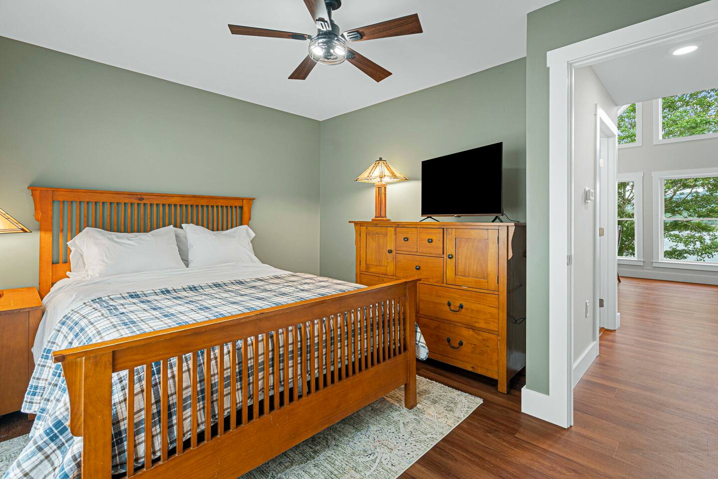 Hudson Room has a queen sized bed, Roku TV, overhead fan, and (as with all our bedrooms) blackout curtains.  A closet with hangers is behind the photographer