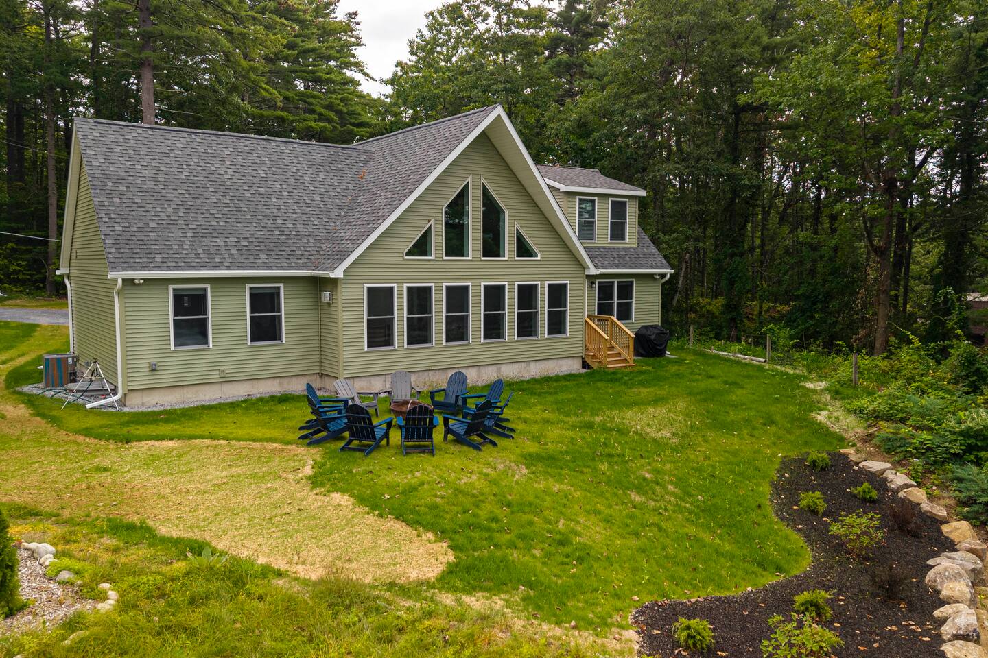 The large lawn (we call the river side the "front") is great for playing games, grilling, and relaxing around a campfire.  Solar lights and hanging lights have been added; please excuse the new grass in the photo (it is filled in now)