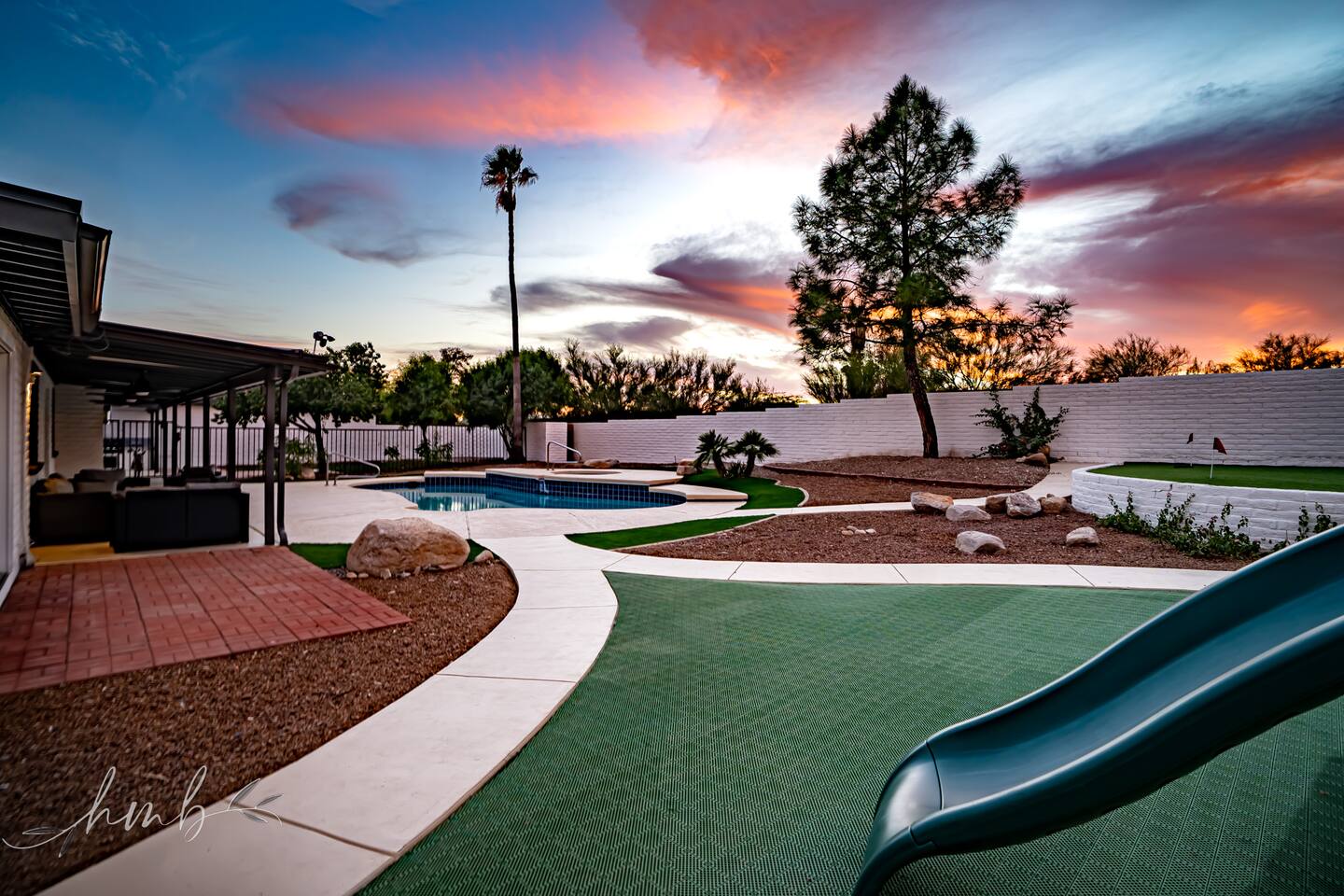 Ultimate Backyard Fun: Dive into the pool or hot tub, play on the slide, practice on the putting green, and unwind on the back patio—all while enjoying stunning Tucson sunsets. Perfect for fun-filled days and relaxing evenings.