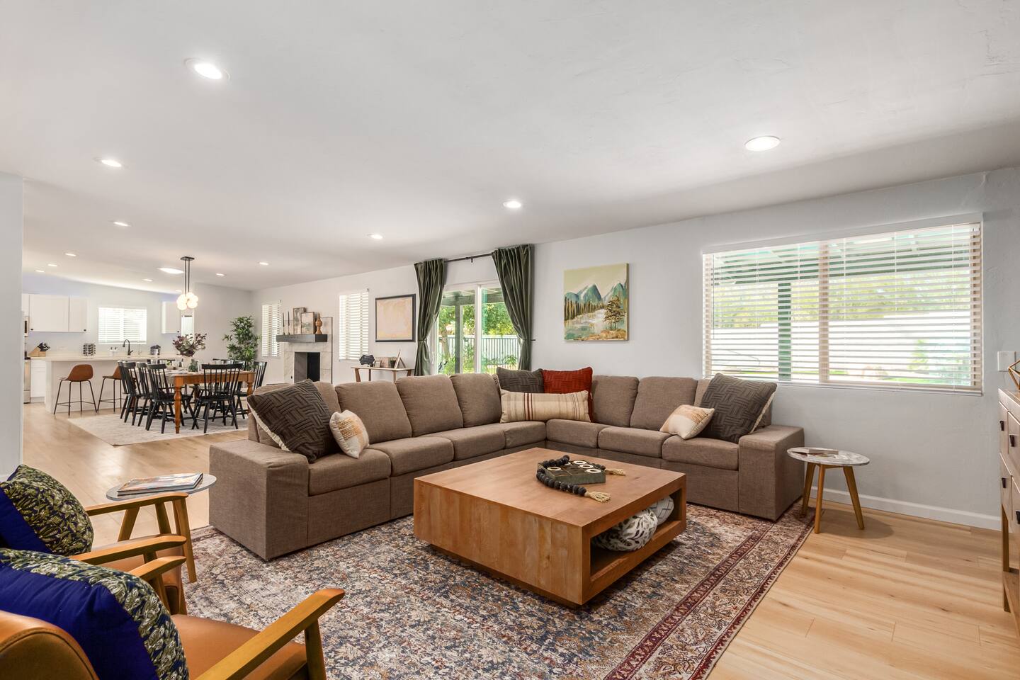 Enjoy the spacious open layout connecting the living, dining, and kitchen areas — ideal for families and groups. Natural light fills the room, highlighting the earthy tones, soft textures, and inviting atmosphere of this Tucson getaway.