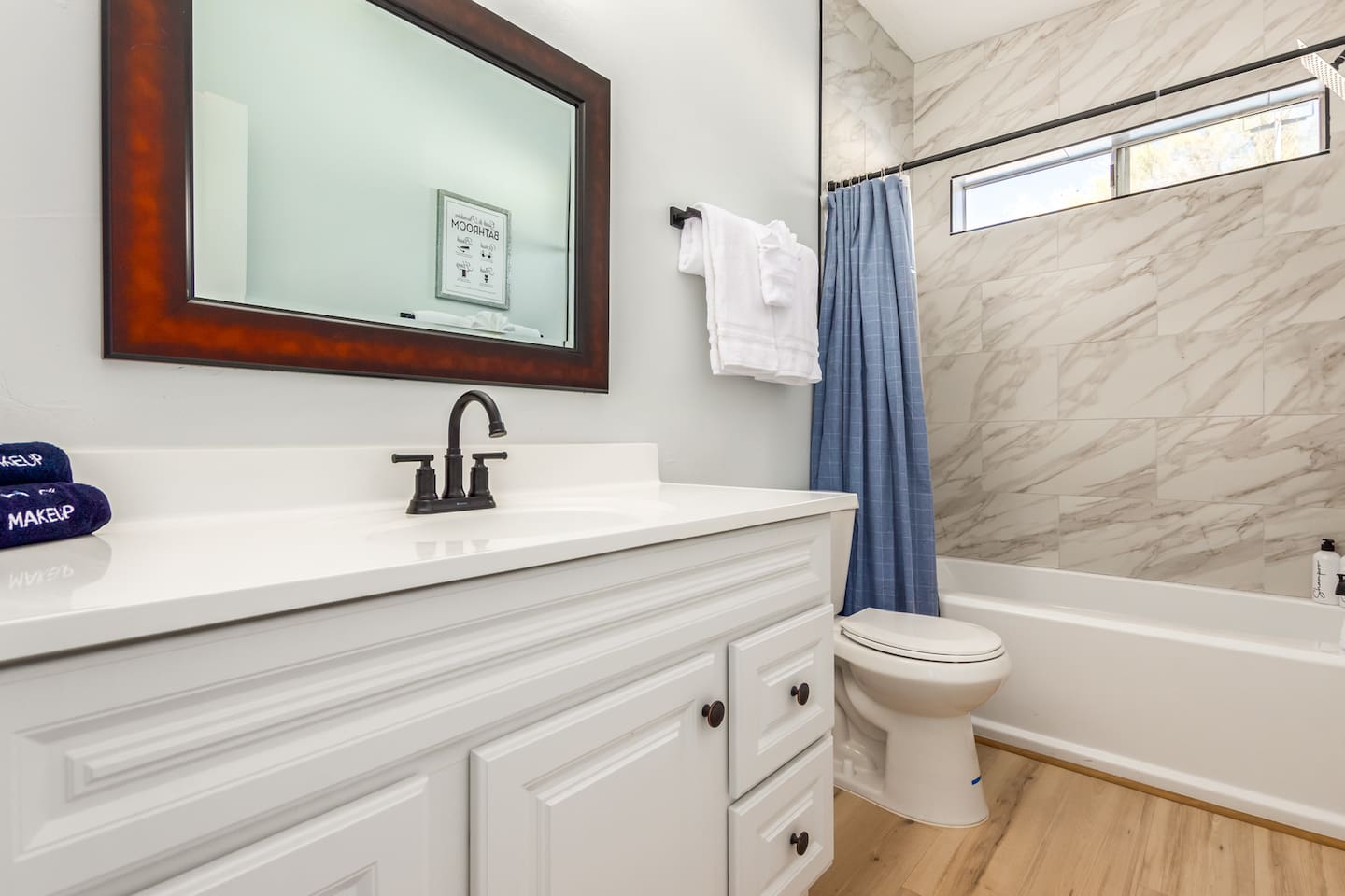 Stylish hall bathroom featuring a sleek single-sink vanity and a bath-shower combo—designed for comfort and convenience.