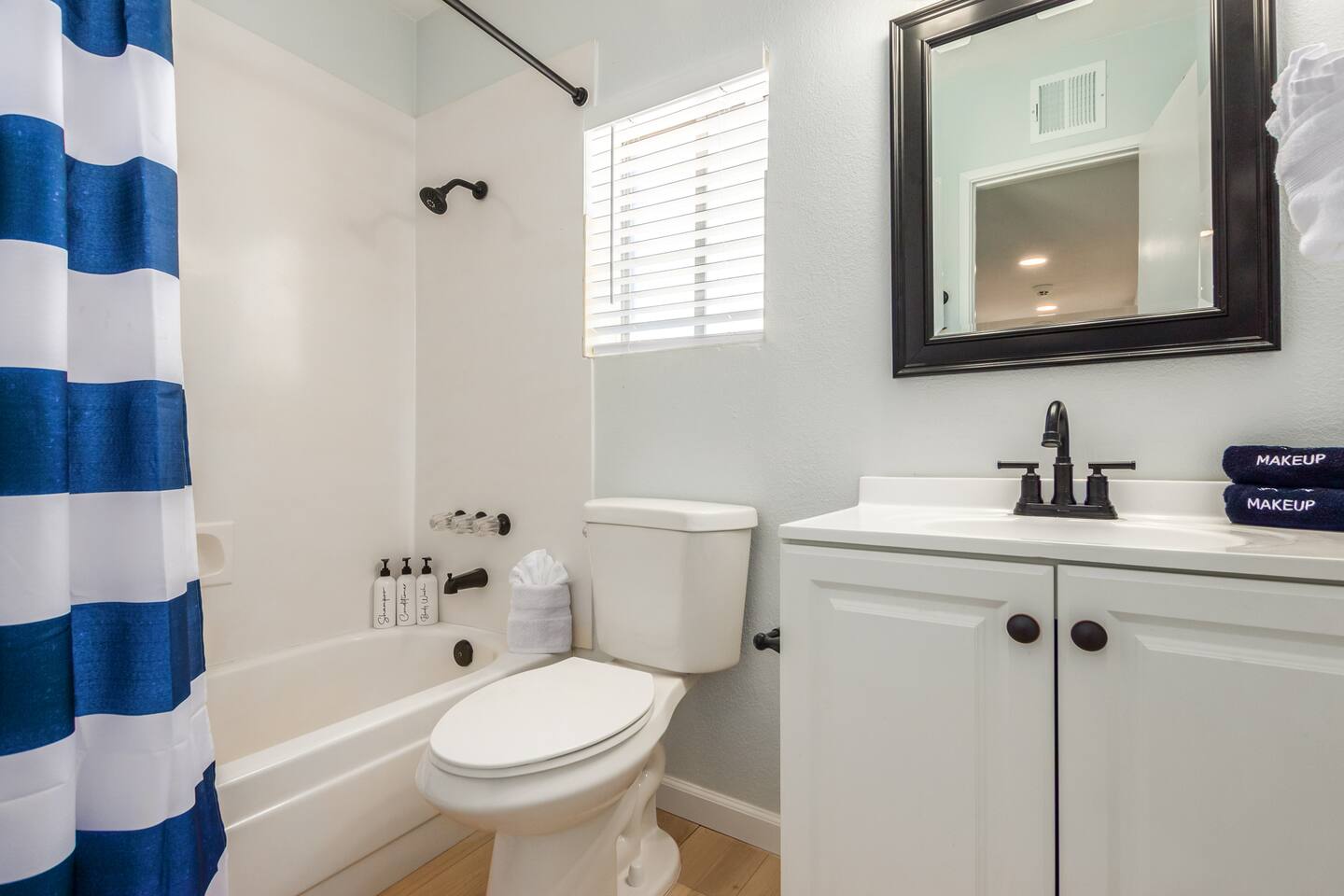 Guest House Bathroom: Bright and inviting, with a single-sink vanity and tub/shower combo—perfect for relaxing after a day of exploring.