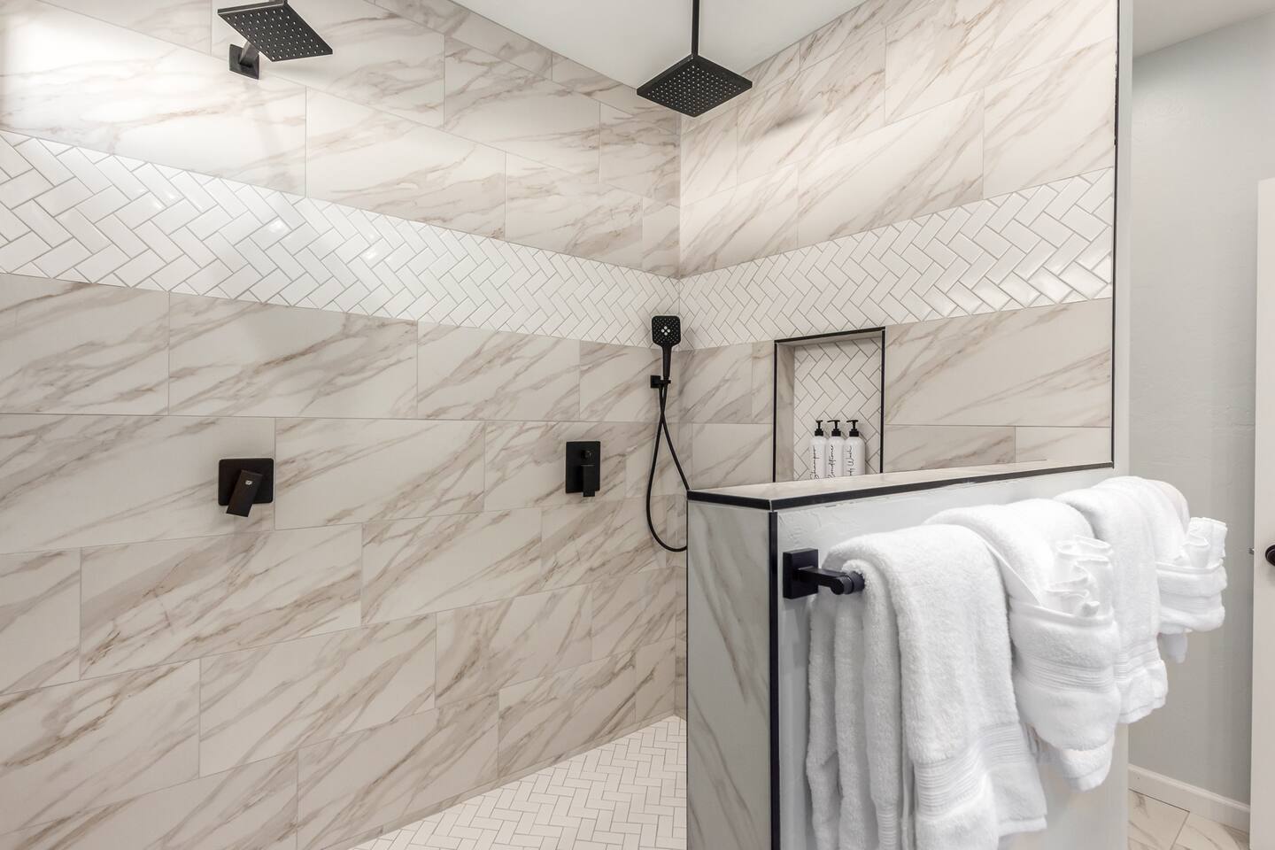 Primary bedroom’s en-suite bathroom features a spacious walk-in shower with double shower heads—perfect for a spa-like experience.