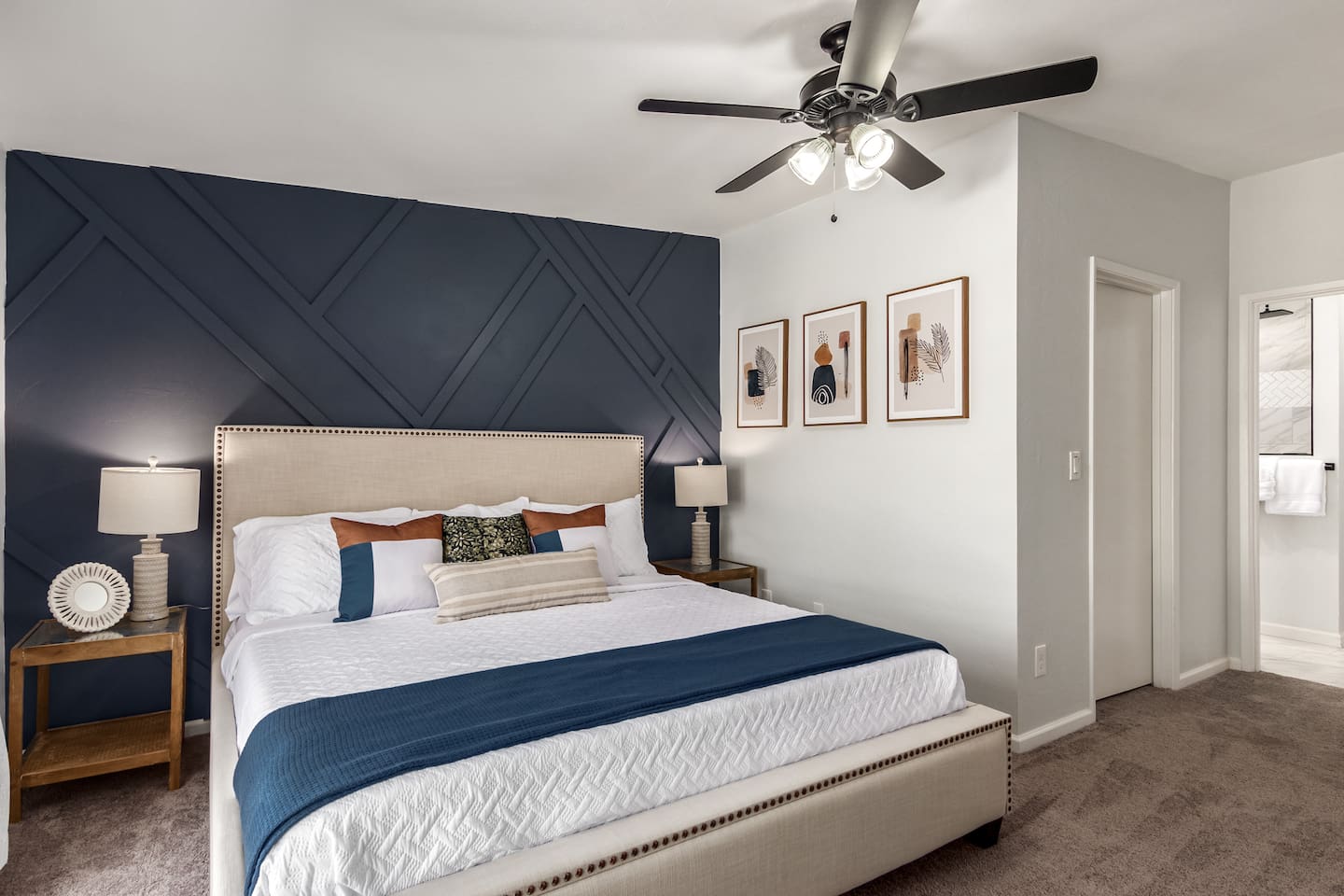 Bright and spacious primary bedroom with a king-size bed, desk, and TV—perfect for relaxing or catching up on work.