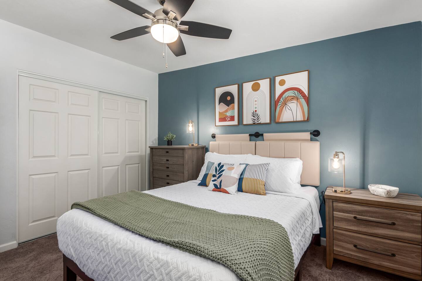 Settle in for a cozy night with a 55" TV and plush queen bed in this stylish room designed for comfort and rest.
