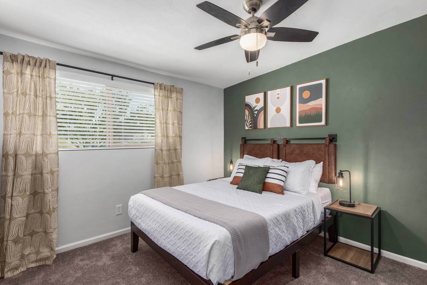 Relax in this stylish bedroom featuring a queen bed and soothing green accent wall—perfect for a restful night’s sleep.