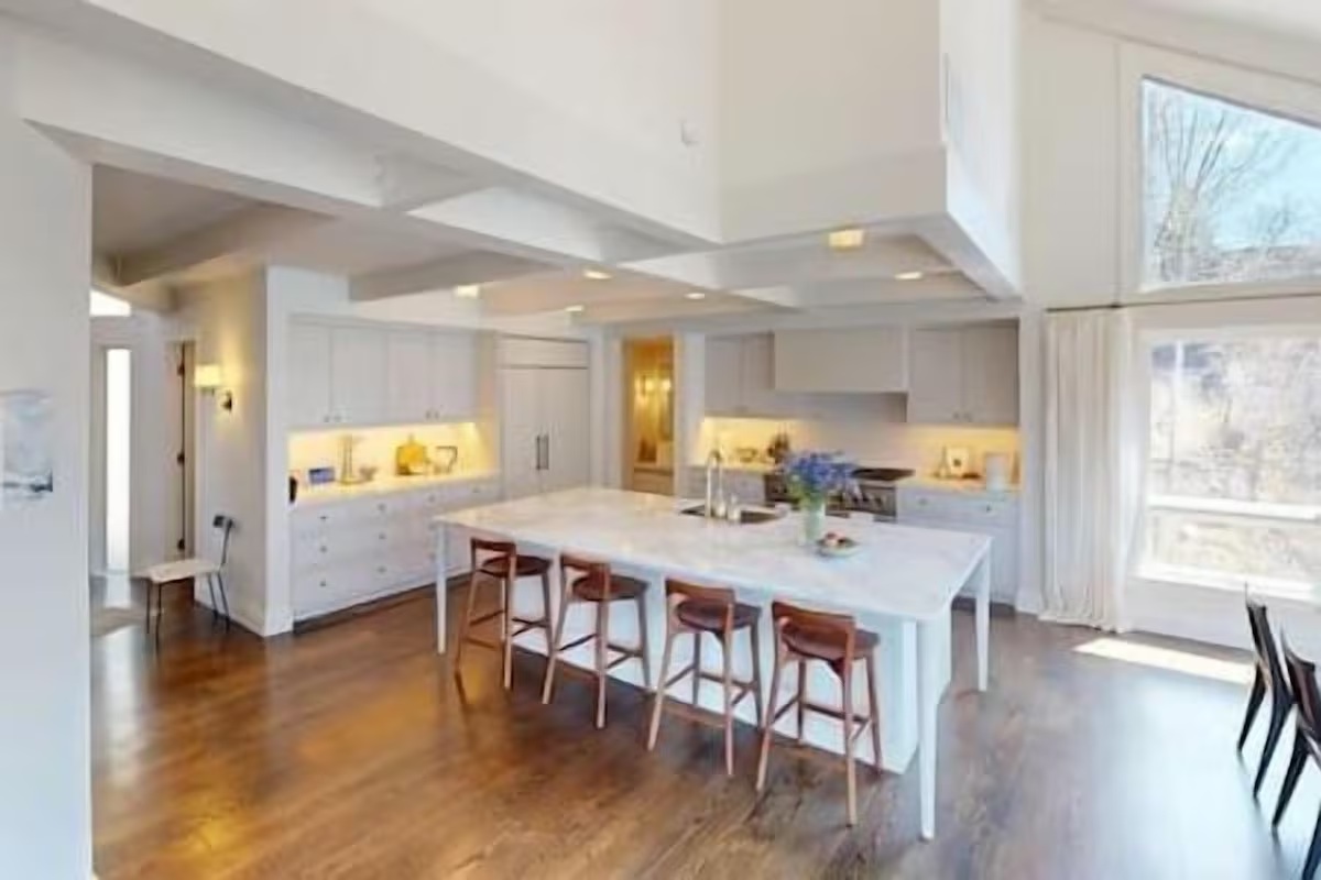 Bright designer kitchen with oversized island and soaring ceilings