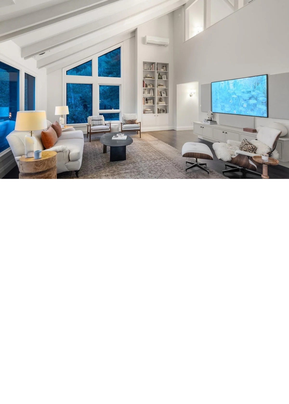 Airy vaulted living room with huge windows and stylish cozy seating
