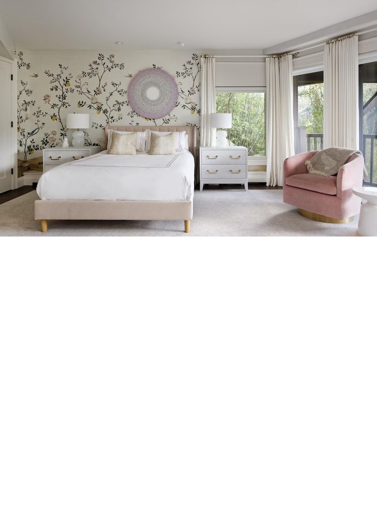 Bright, elegant bedroom with floral wallpaper and serene garden views
