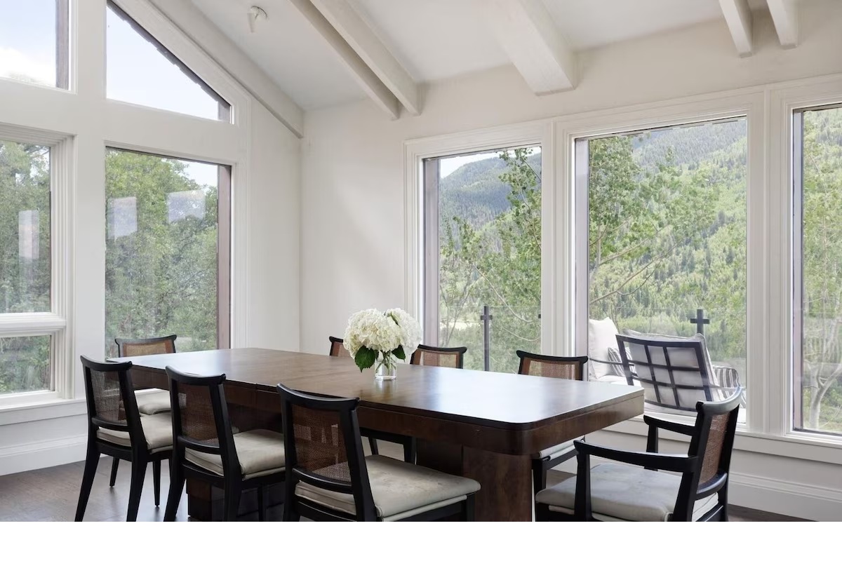 Sunlit dining room with panoramic mountain views and modern elegance
