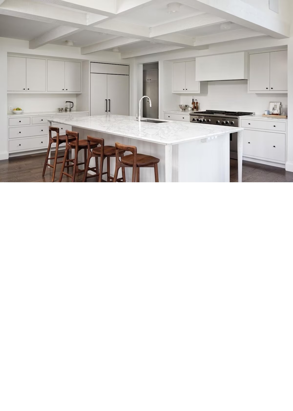 Bright designer kitchen with oversized marble island and bar seating