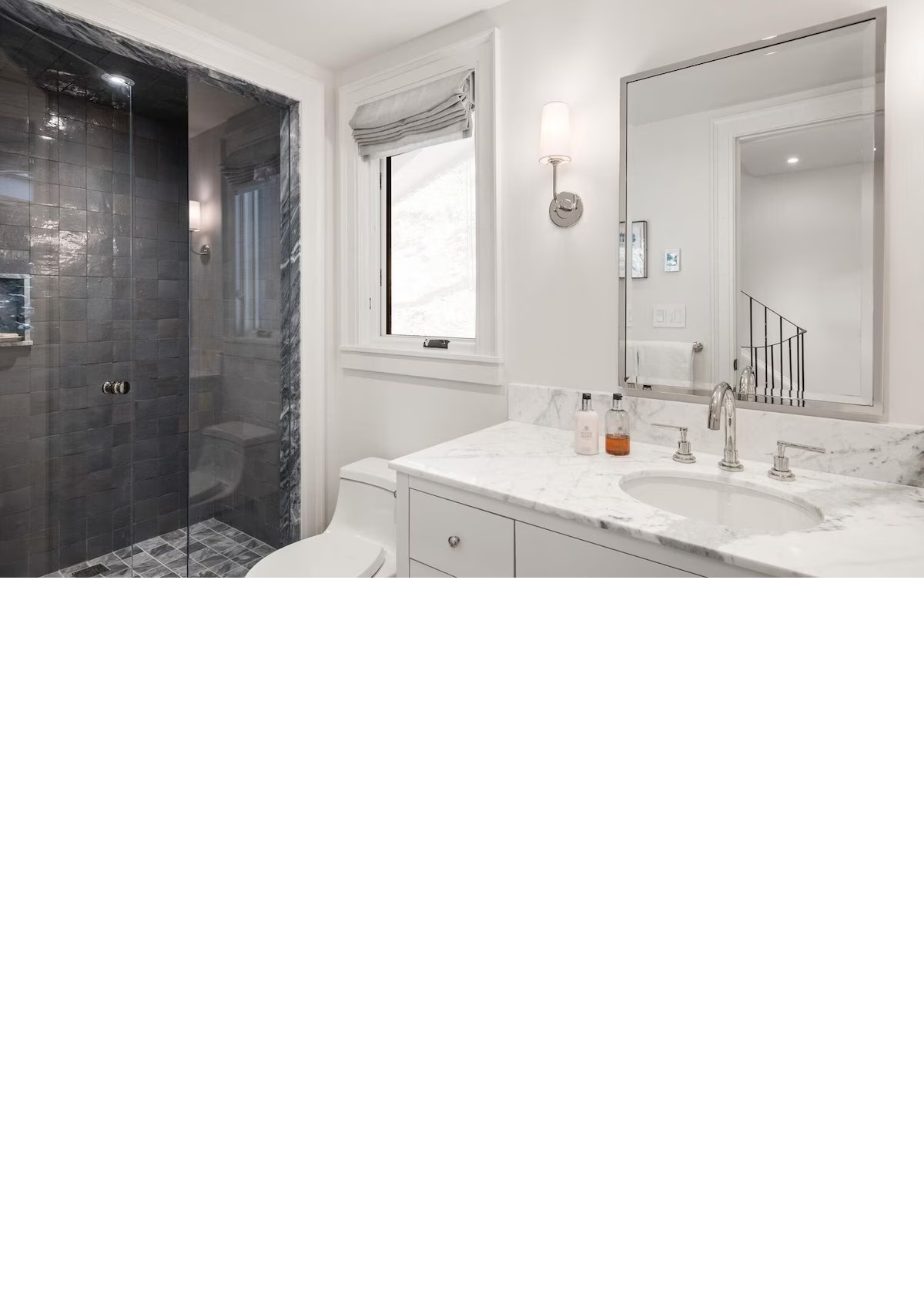 Bright luxe bathroom with marble vanity and glass walk-in shower