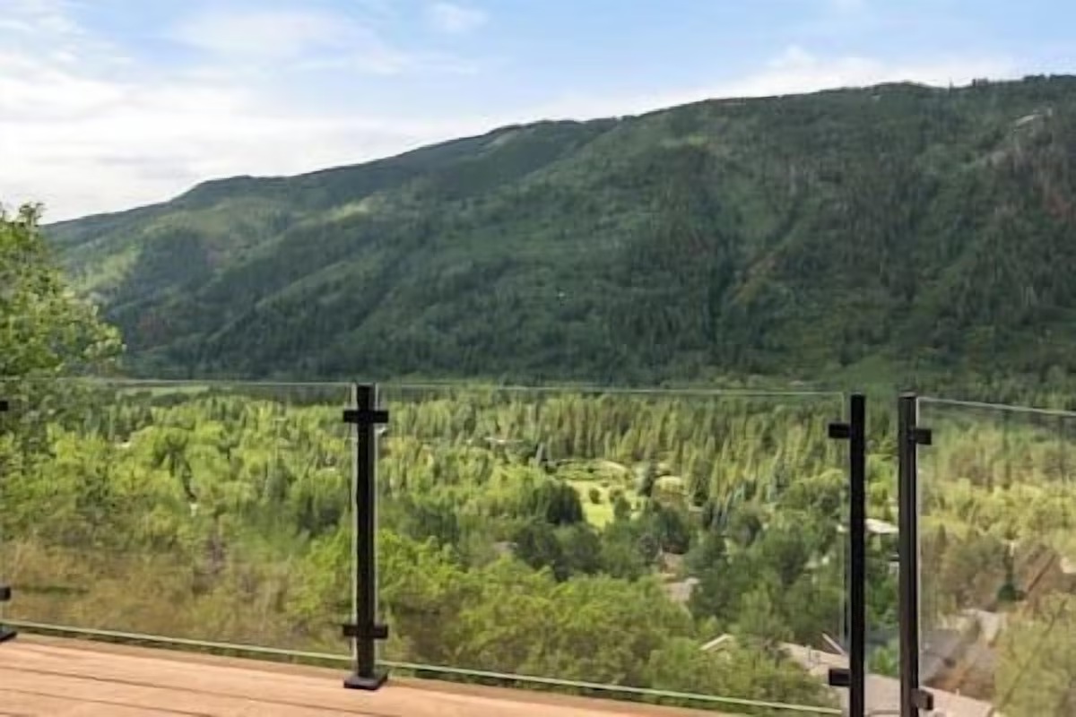 Scenic mountain-view deck with glass railing and sweeping valley vistas