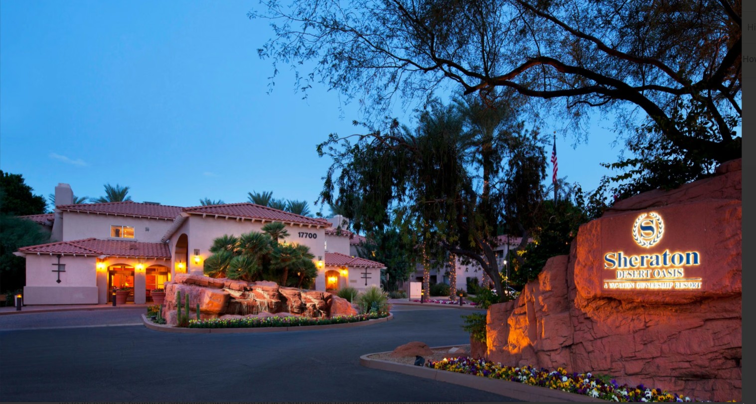 Elegant resort entrance with desert landscaping and warm evening glow