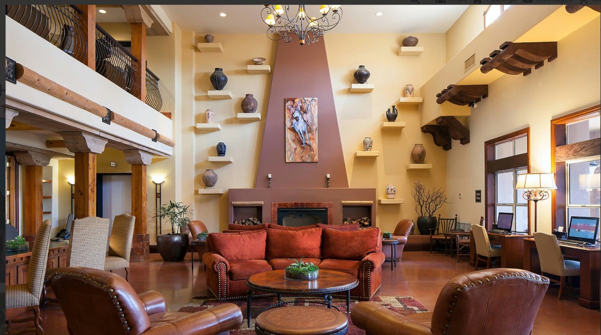 Grand Southwestern lounge with fireplace, loft, and cozy leather seating