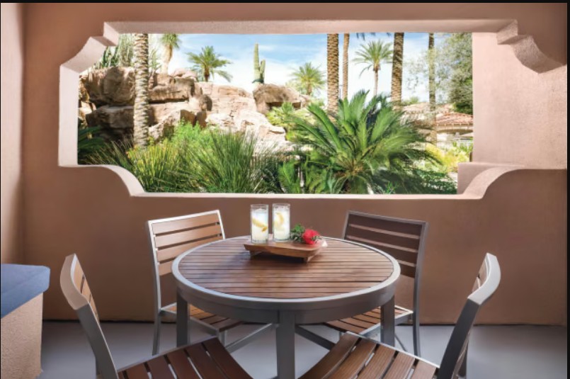 Private patio dining with lush tropical garden and resort-style views