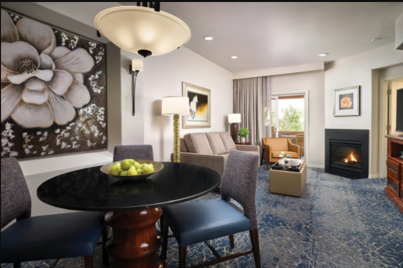 Cozy suite with fireplace, dining area, and bright, inviting lounge
