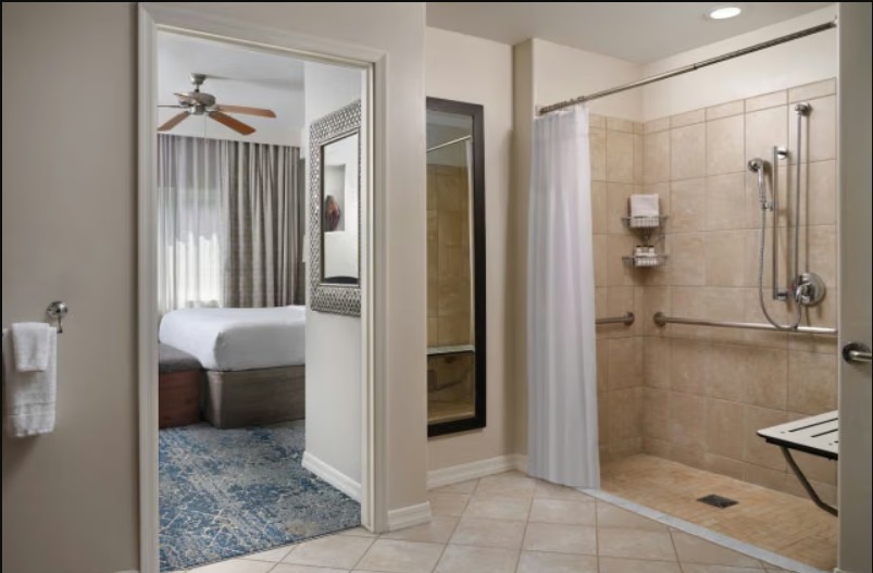 Spacious suite bath with walk-in shower and adjoining cozy bedroom