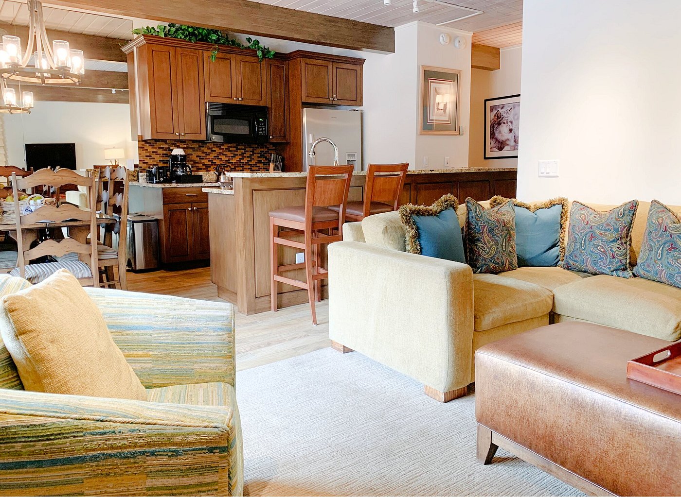 Cozy open living area with breakfast bar, dining space, and rustic charm