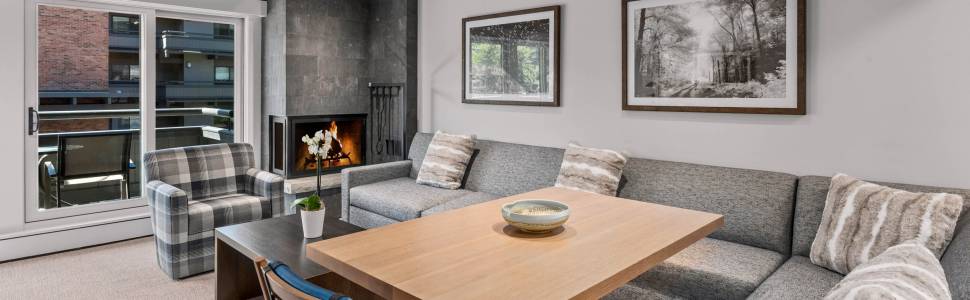 Cozy lounge with fireplace, sectional seating, and bright modern style