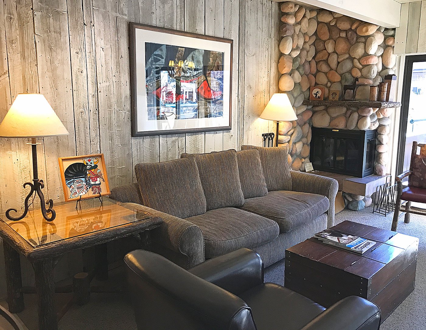 Cozy rustic living room with stone fireplace and warm lodge charm