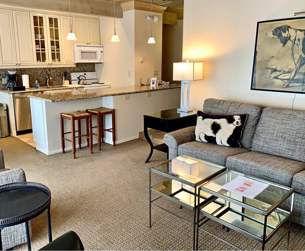 Bright open living room with granite breakfast bar and stylish seating
