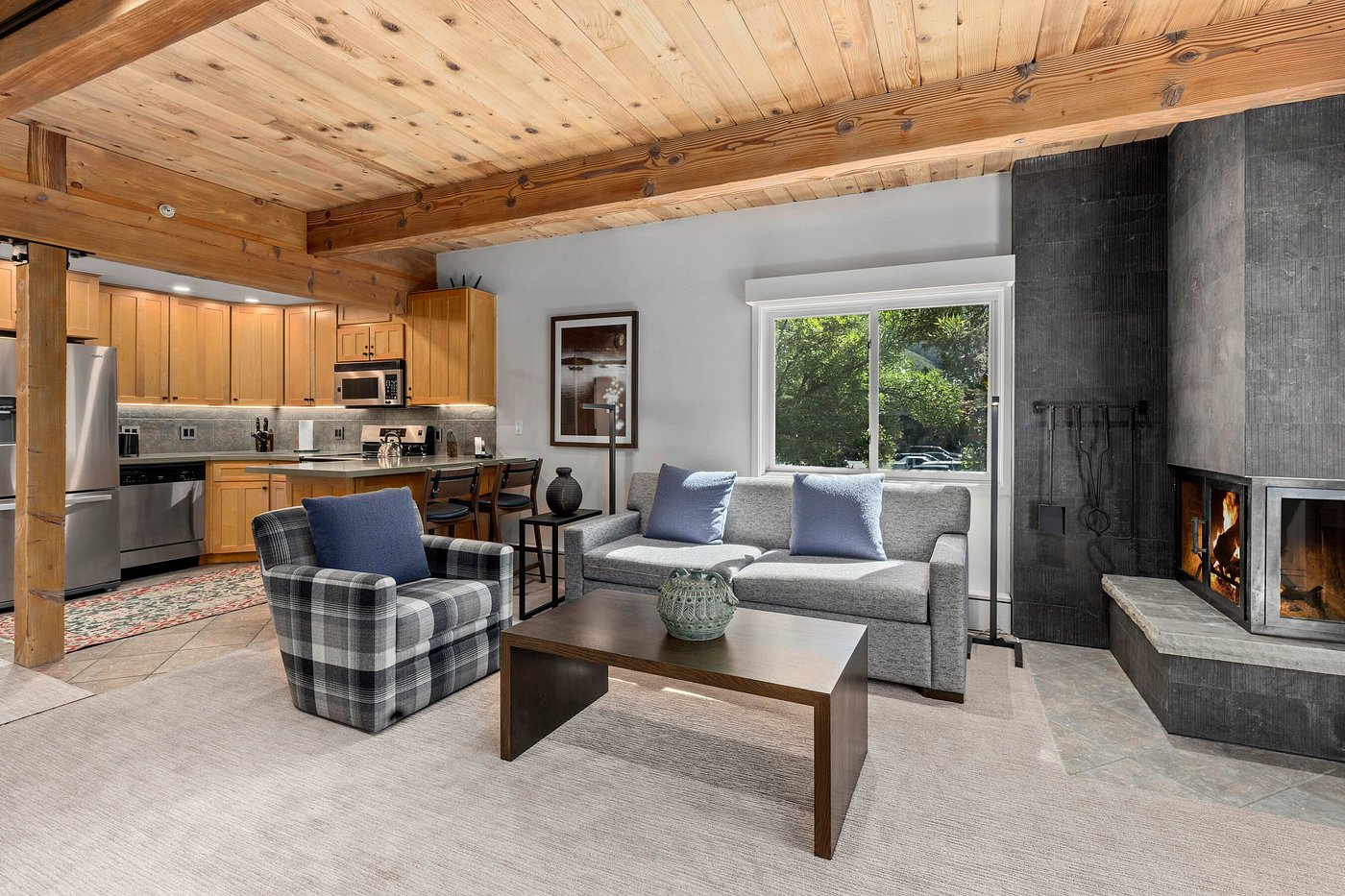 Cozy mountain-style living room with fireplace and open kitchen