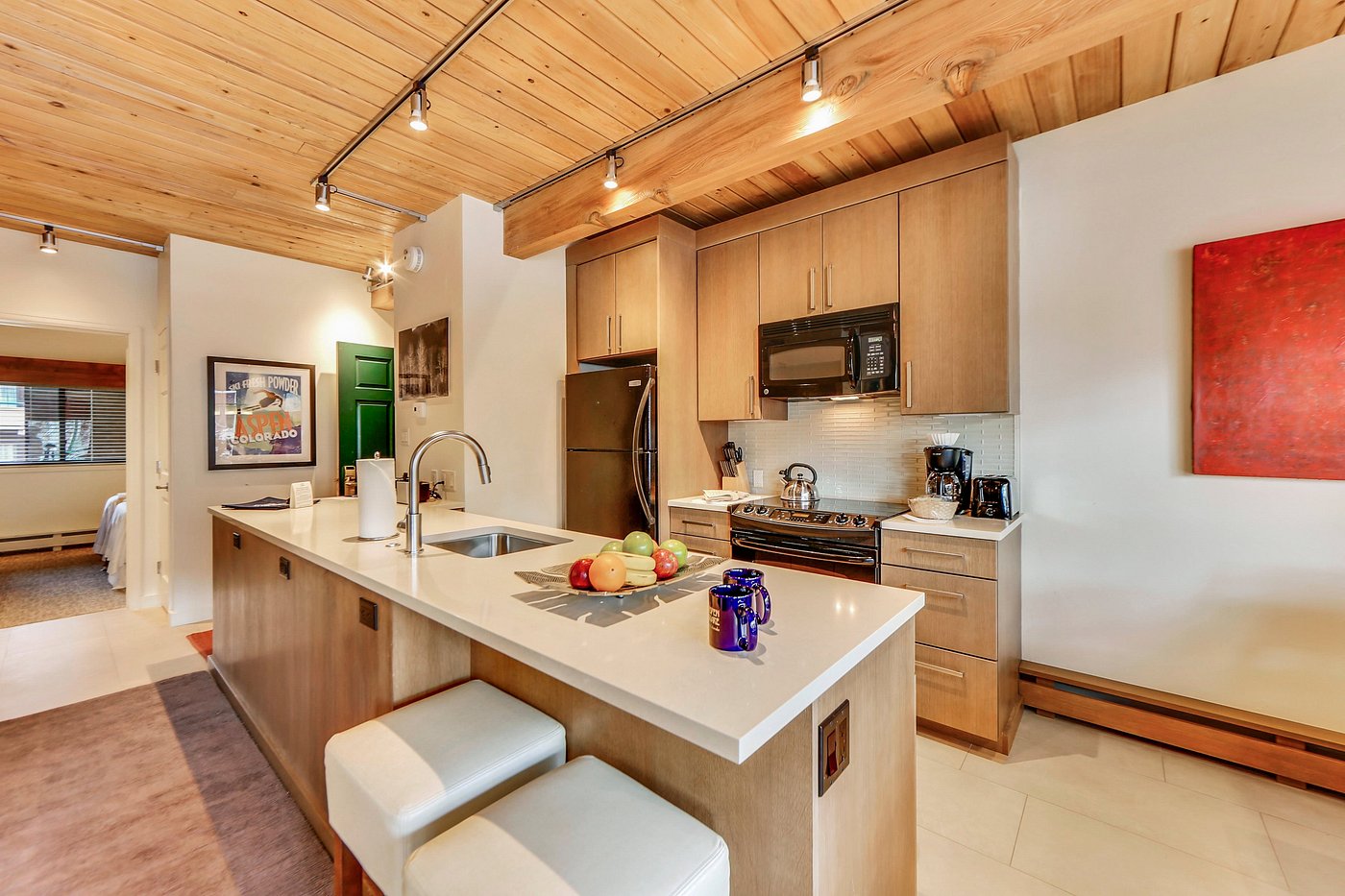 Modern mountain-style kitchen with large island and warm wood finishes