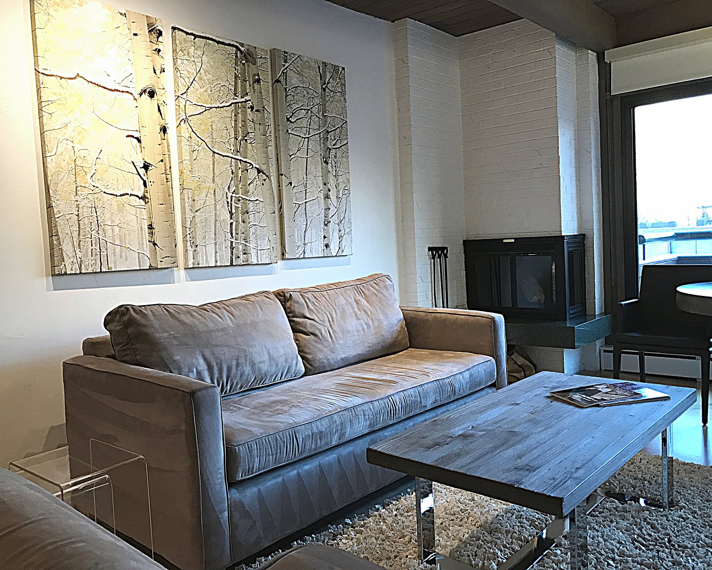 Cozy living room with fireplace, plush sofa, and stylish modern decor