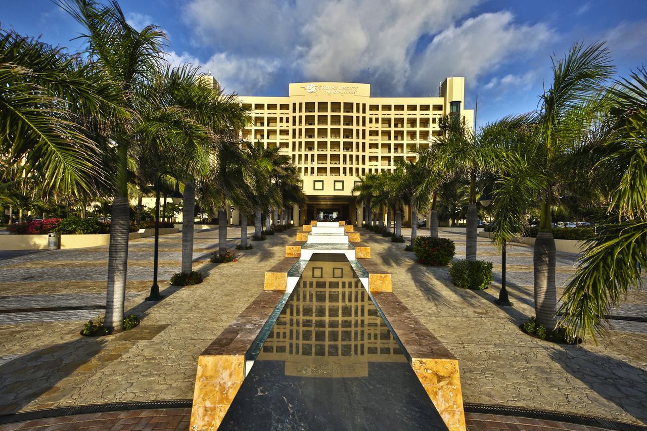 Grand palm-lined entrance with reflecting pool and resort-style elegance