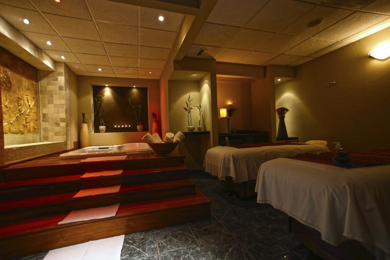 Luxurious spa room with massage tables and soaking tub retreat