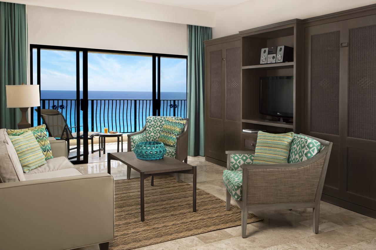 Bright oceanview living room with private balcony and stylish seating