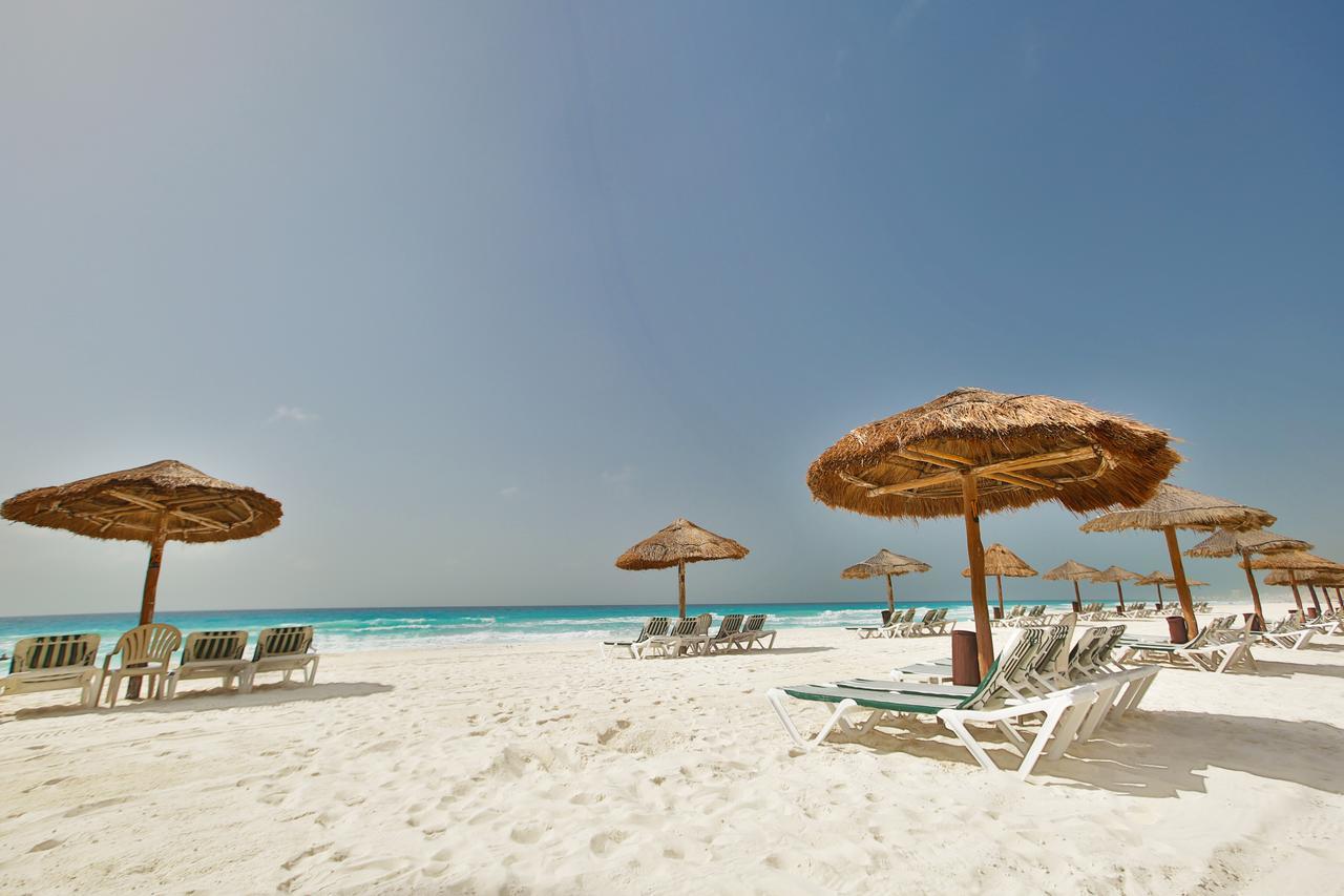 Relax on a pristine white-sand beach with shaded loungers and turquoise views