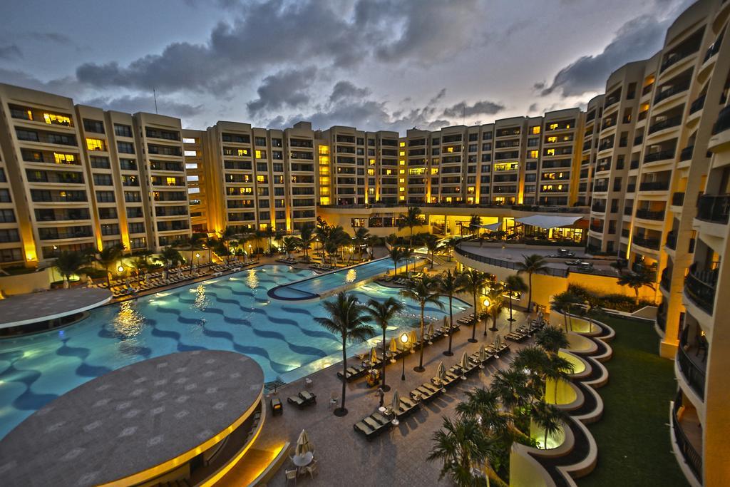 Stunning resort-style pool courtyard with glowing evening ambiance