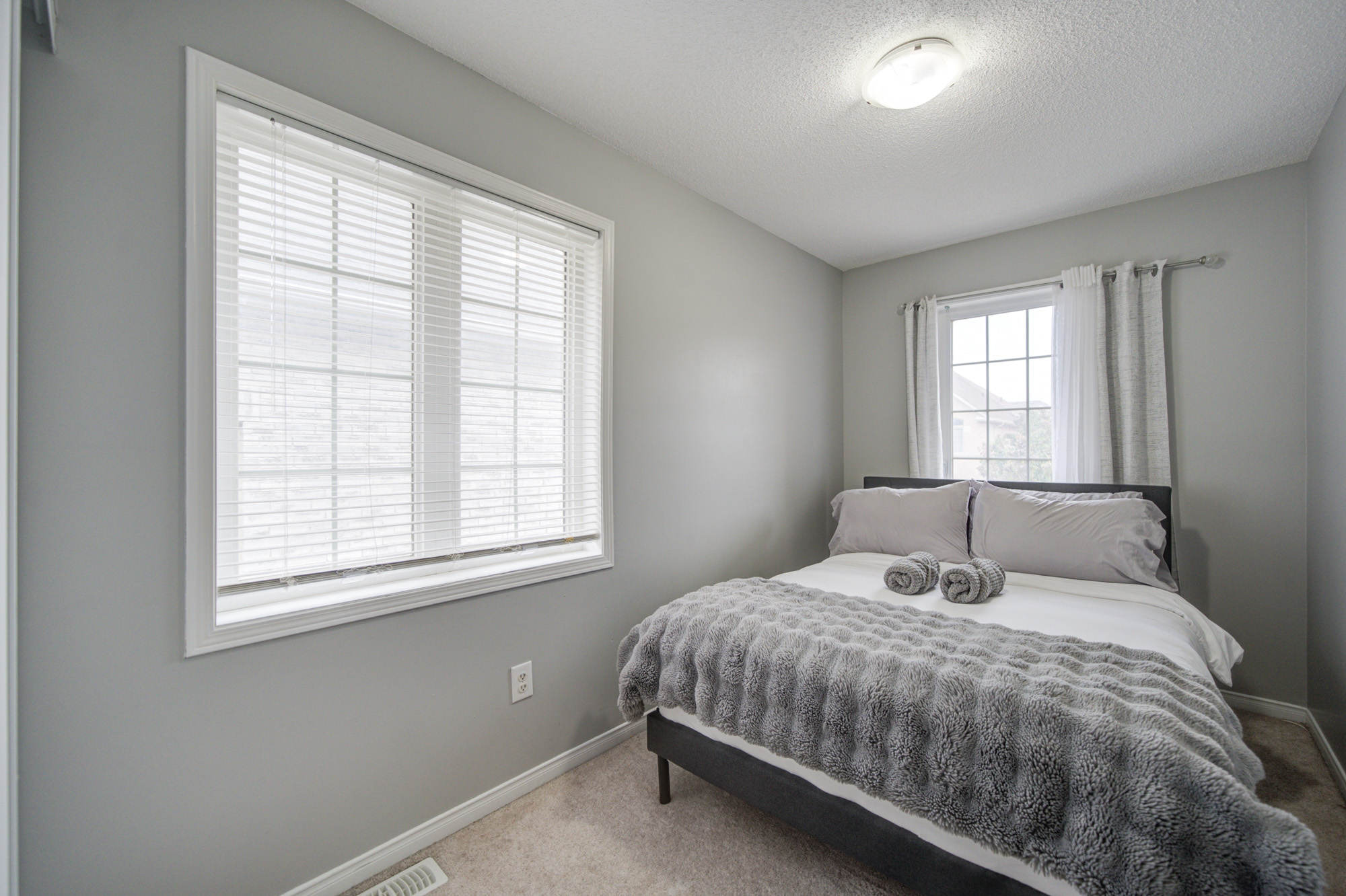 Bright, cozy bedroom with plush bedding and beautiful natural light