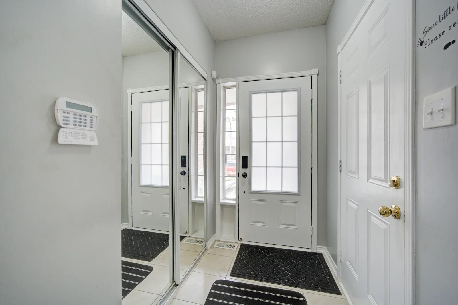 Bright, welcoming entryway with mirrored closet and natural light