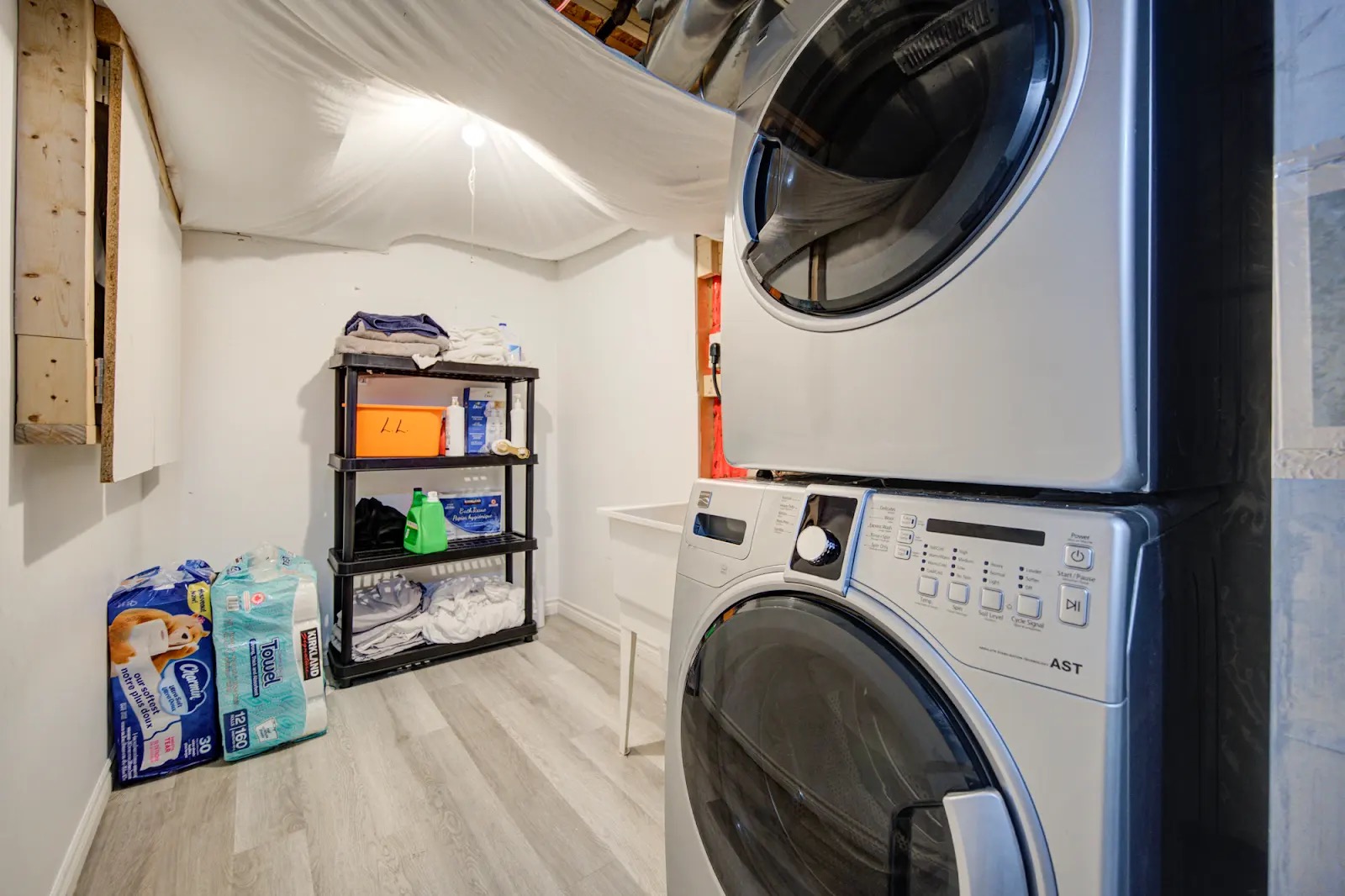Convenient in-home laundry room with washer, dryer, and utility sink