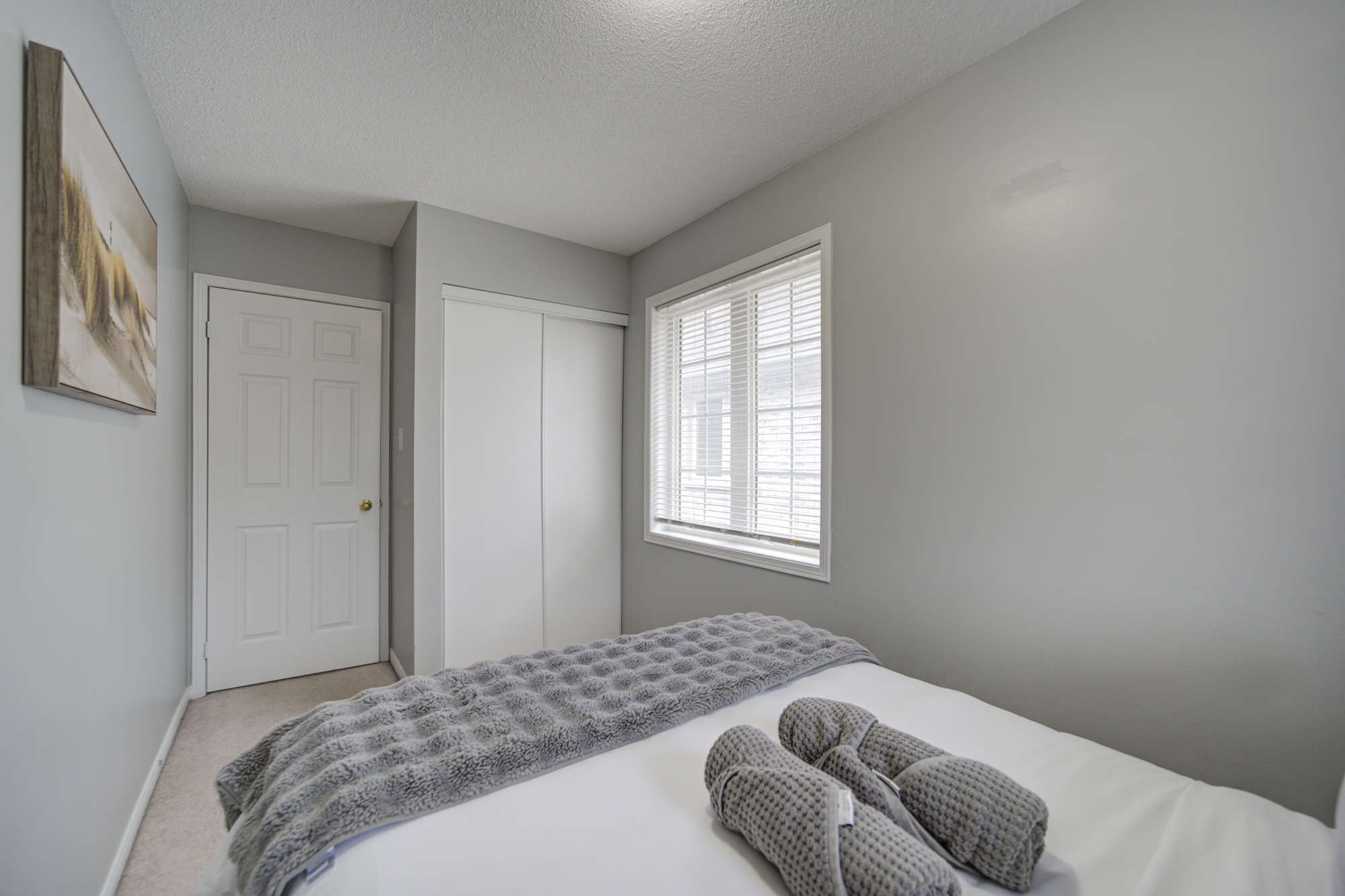 Bright, cozy bedroom with natural light and a calm neutral design