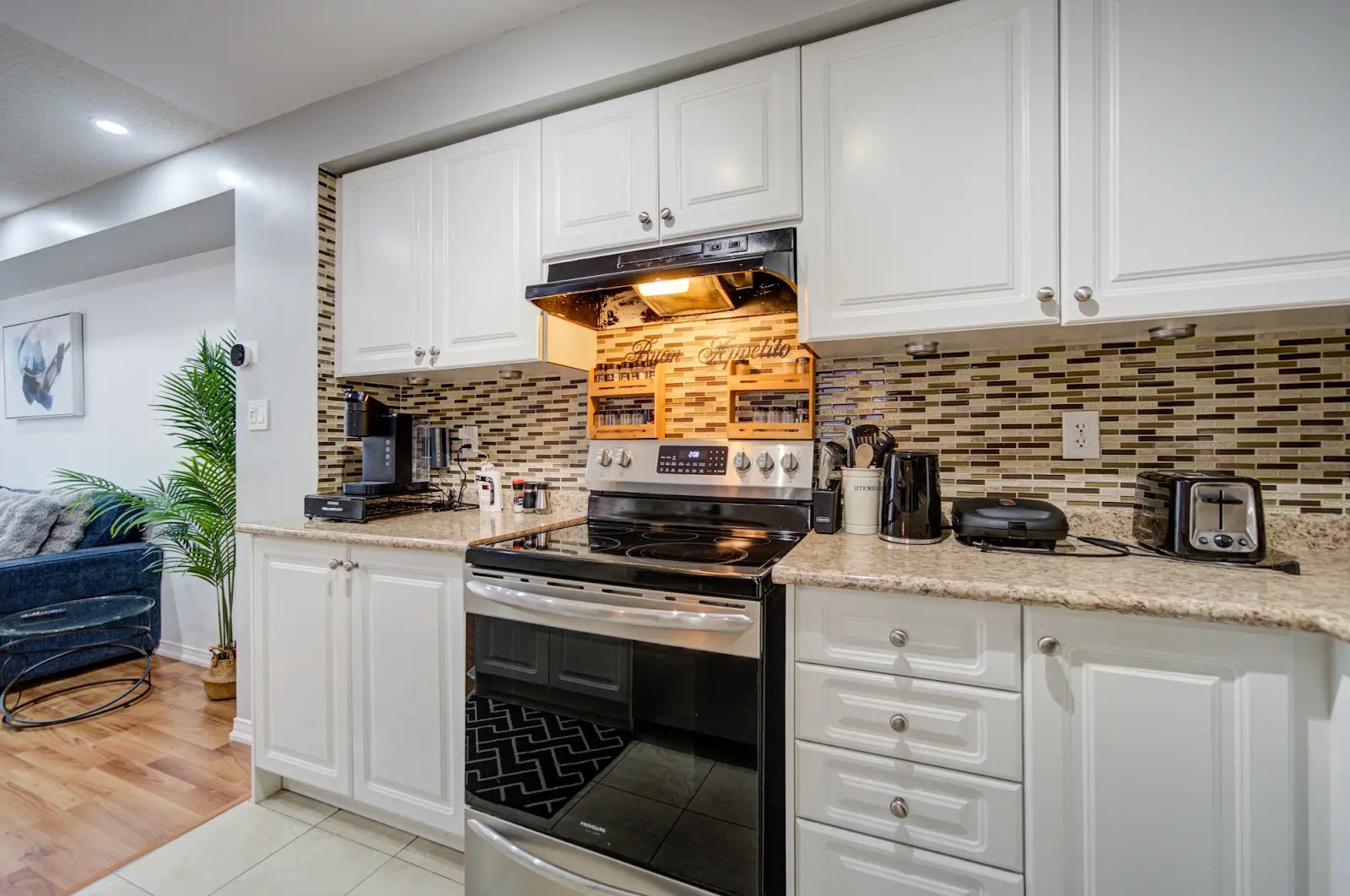 Bright updated kitchen with full-size stove and stylish tile backsplash