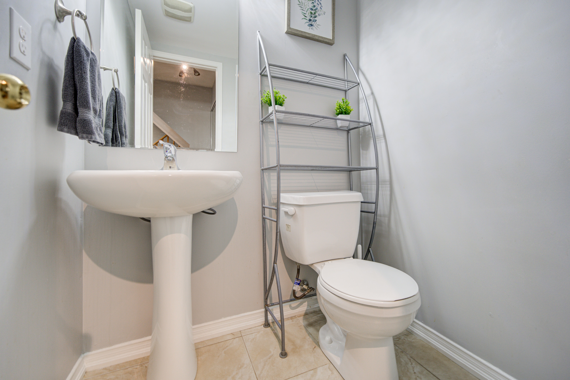 Bright, spotless half bath with stylish storage and modern simplicity