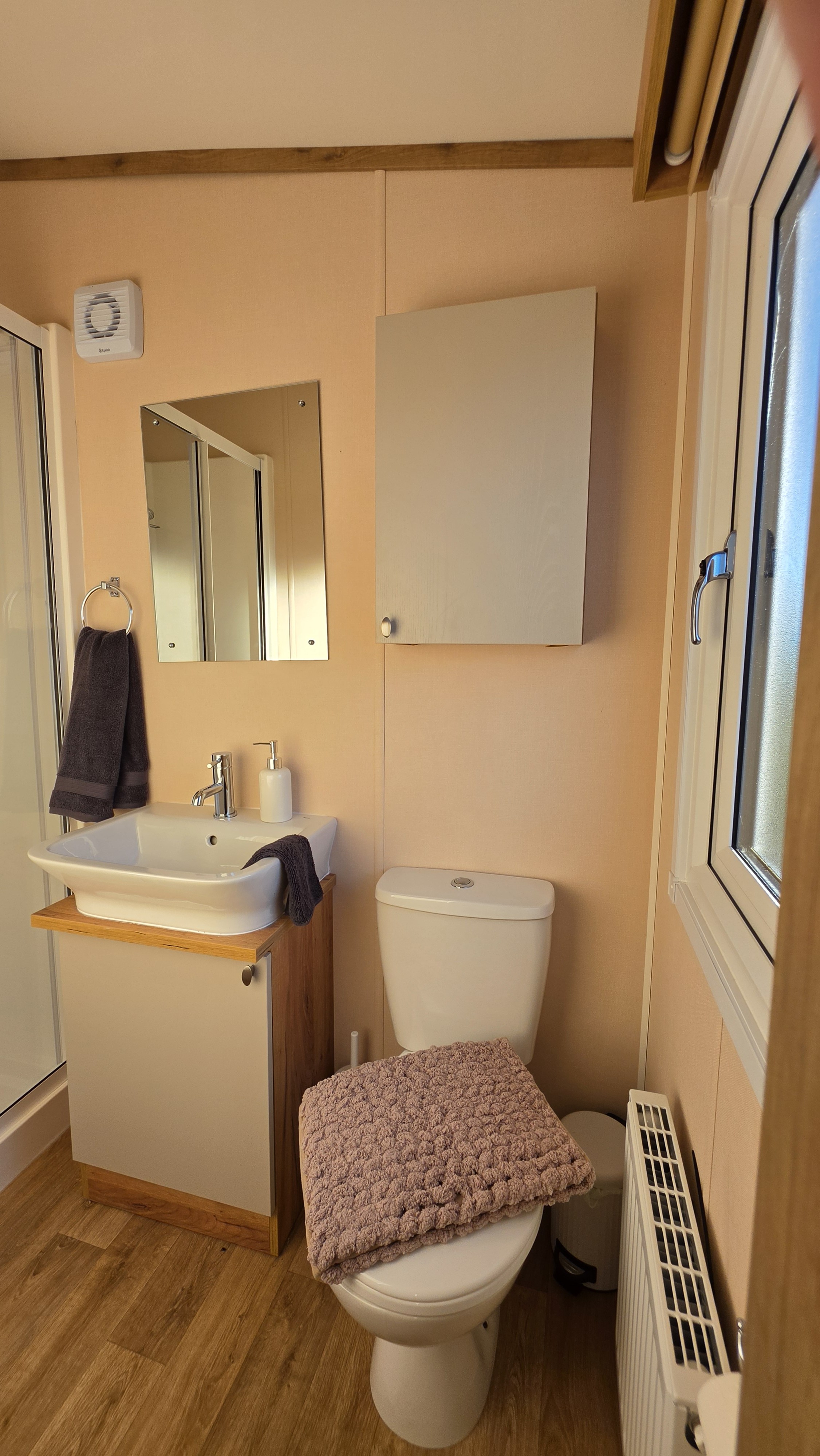 Bright, modern bathroom with shower, vanity, and natural light