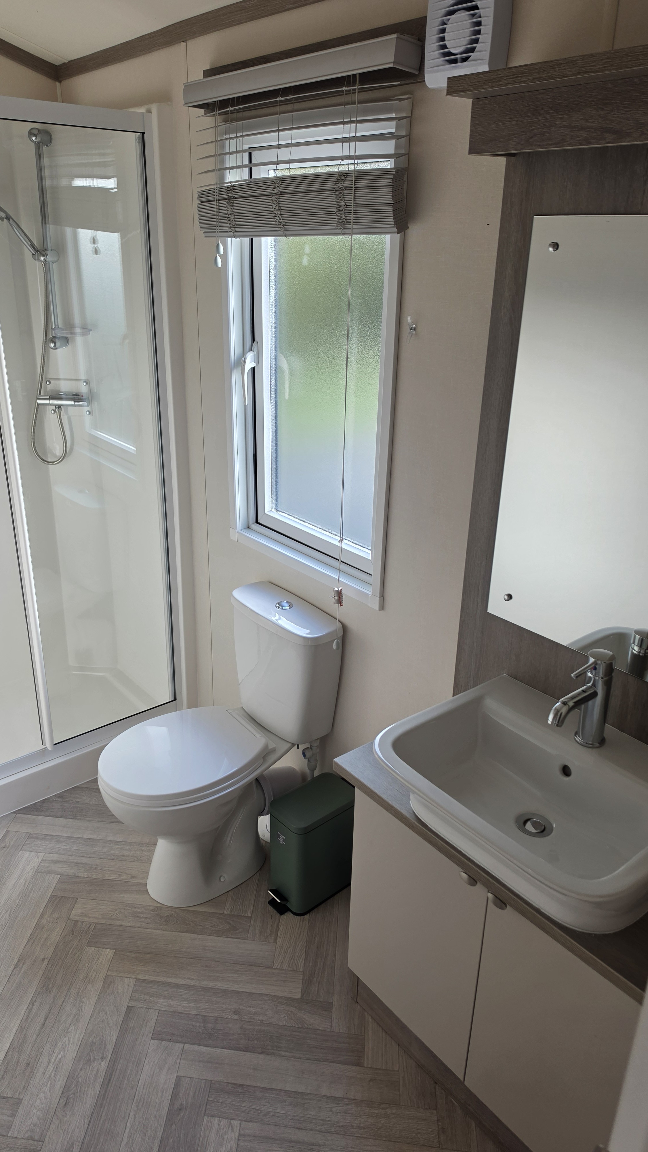 Bright modern bathroom with walk-in shower and natural light