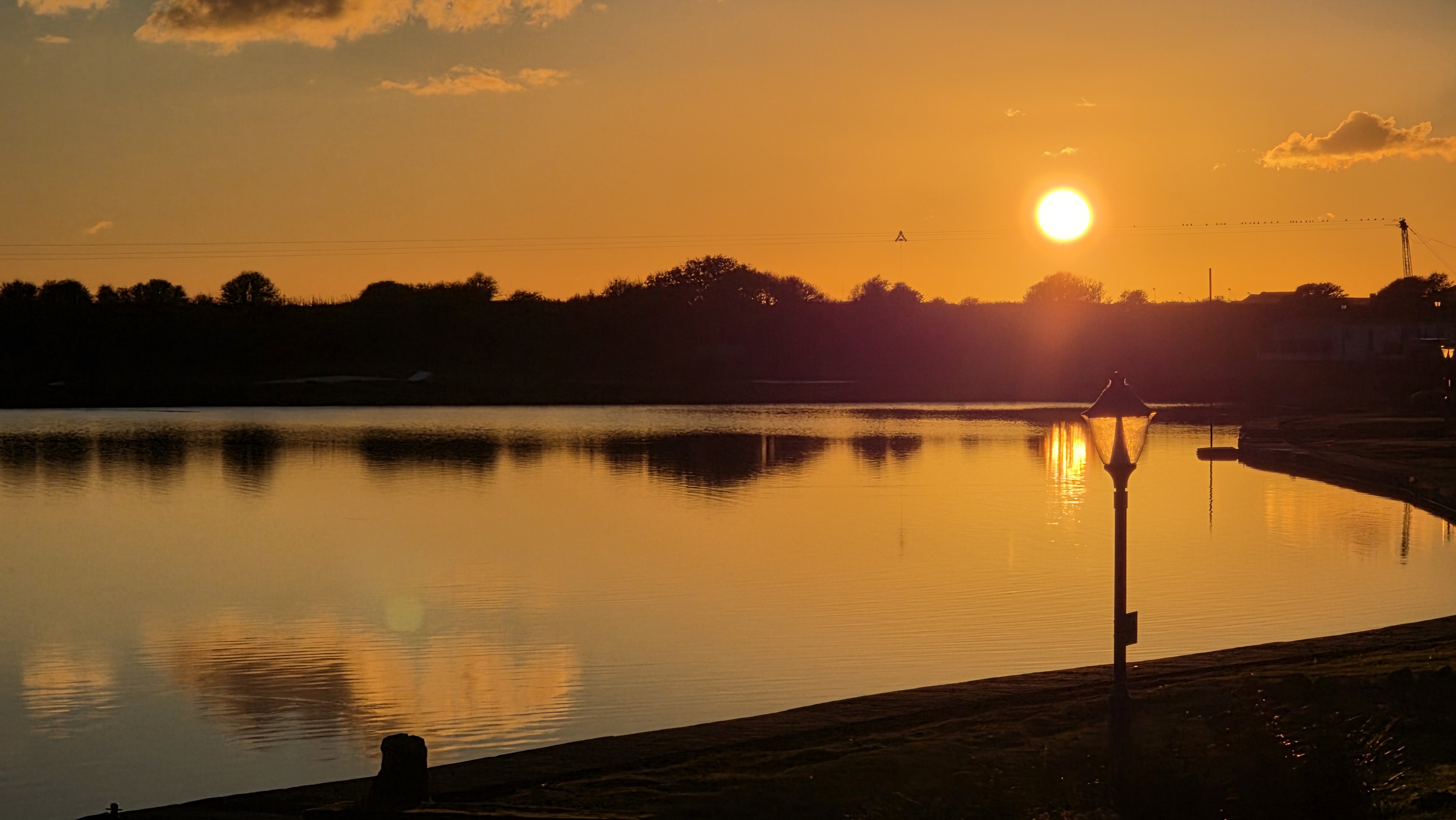 Golden sunset views over the calm lake create a serene waterfront retreat