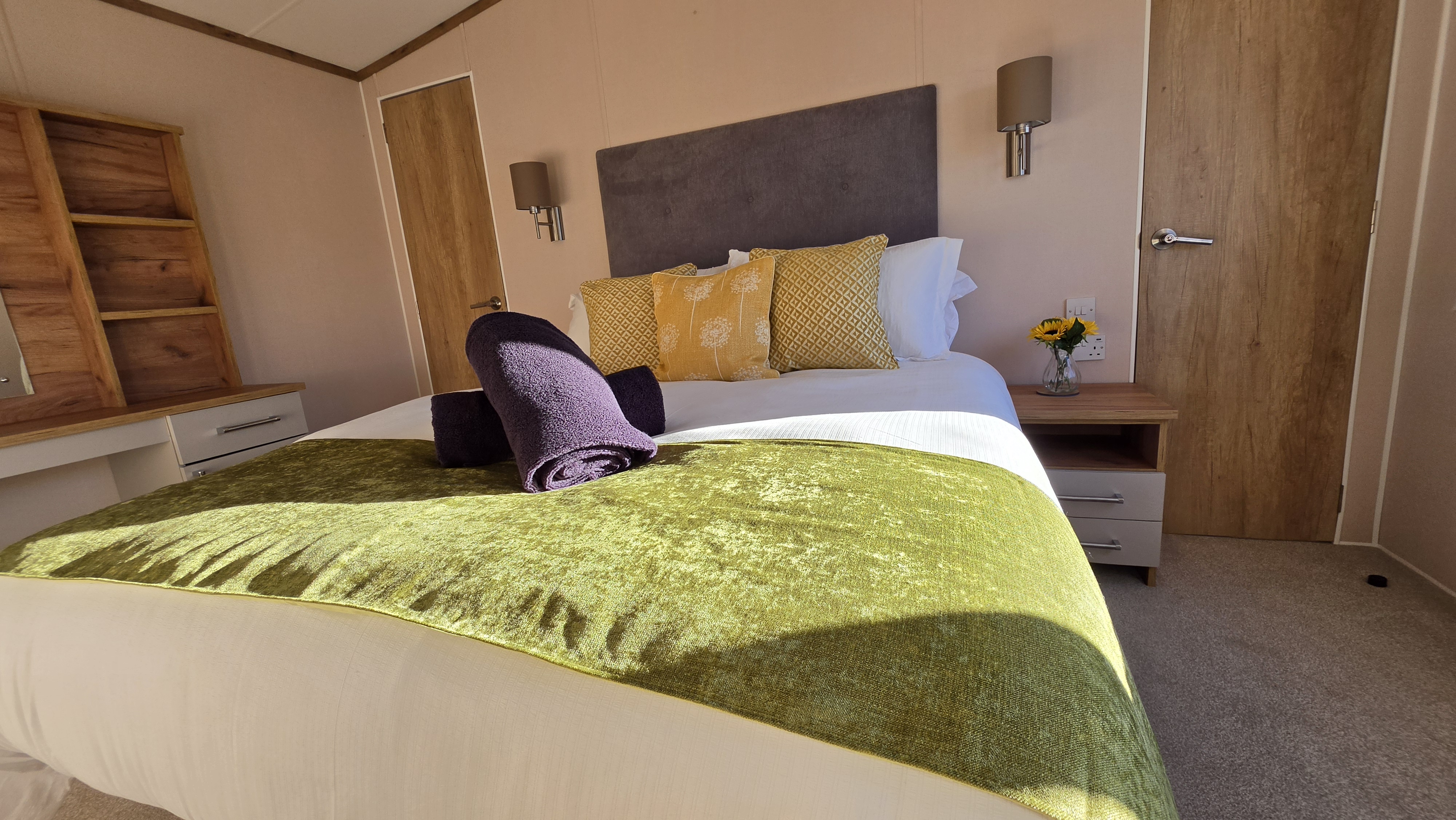 Bright, stylish bedroom with plush bedding and warm modern touches