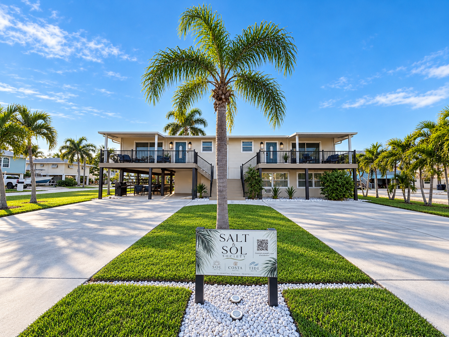 Tropical coastal retreat with palm-lined curb appeal and spacious parking