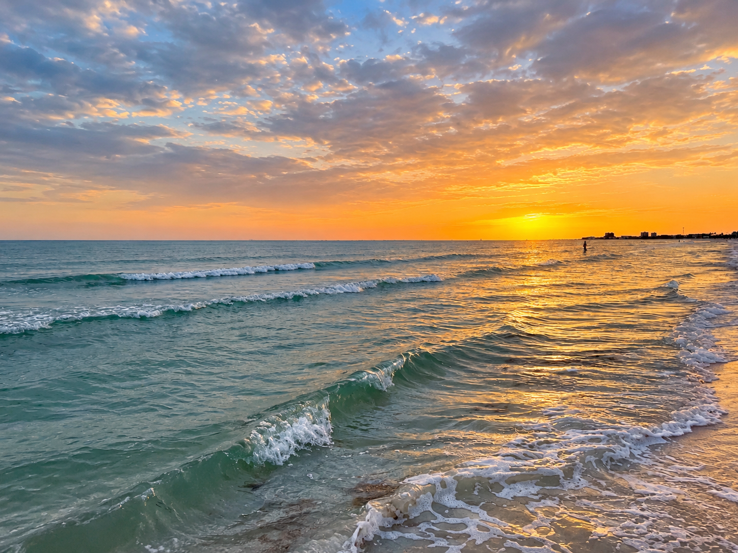 Stunning sunset beach views with gentle waves and golden coastal glow